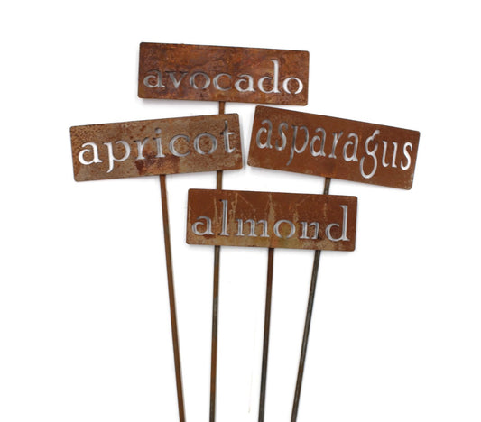 Rusty garden markers for avocado, asparagus, apricot, and almond