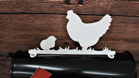 White hen and chick mailbox topper installed on a mailbox.