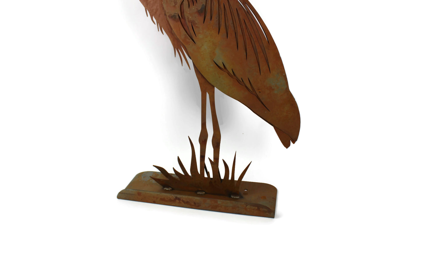 Rusty metal heron statue base close up