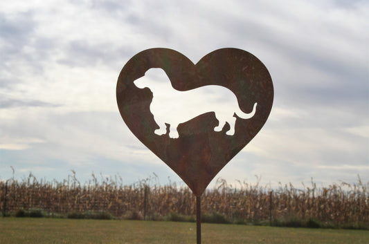 Heart-shaped rusty garden stake sign in rust with a wiener dog dachshund silhouette