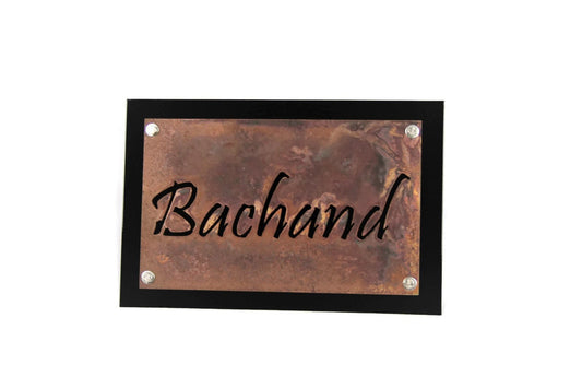 Rust over black metal layered name sign