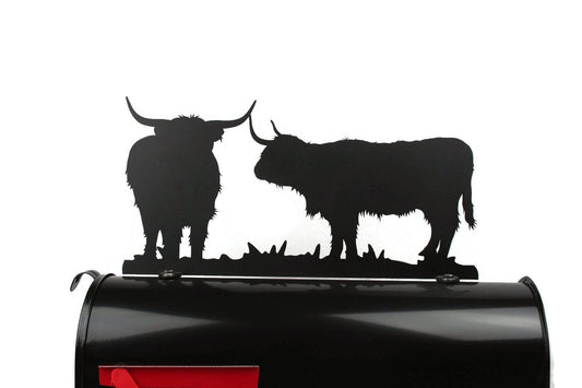 Black highland cattle mailbox topper installed on a mailbox