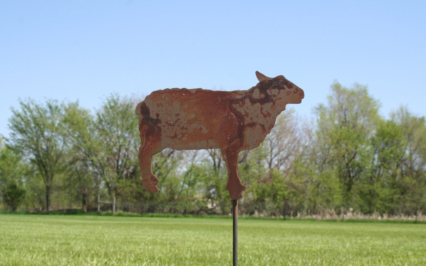 Rusty sheep shaped metal garden stake