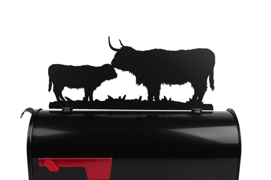 Black highland cow and calf mailbox topper installed on a mailbox