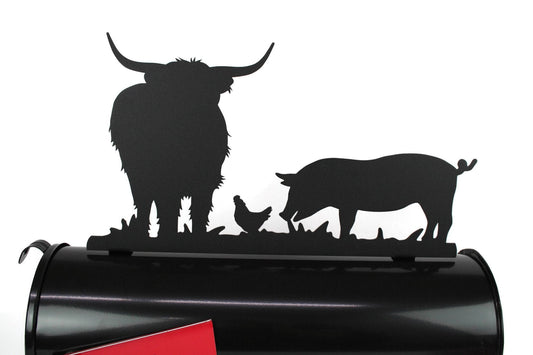 Black highland cow, pig, and chicken mailbox topper installed on a mailbox.