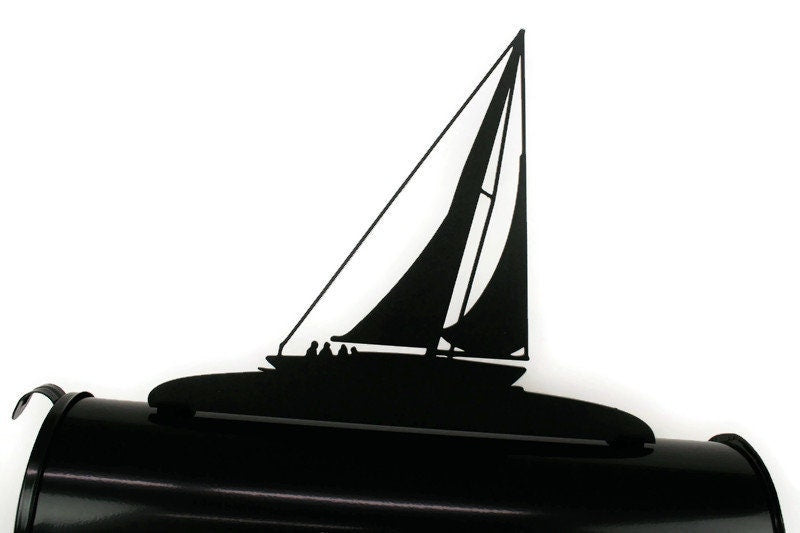 Black sailboat mailbox topper installed on a mailbox