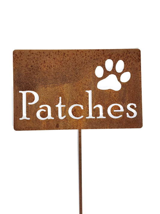 Custom metal garden stake sign in rust with a paw and Patches for text
