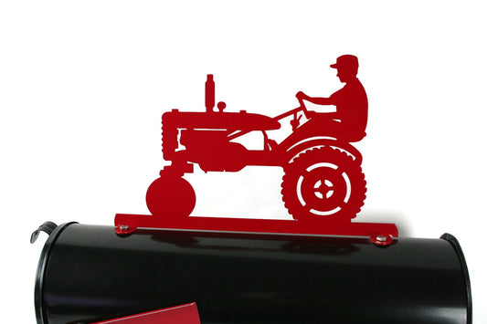 Red vintage tractor and driver mailbox topper installed on a mailbox