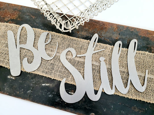 Be Still metal script word sign in raw steel