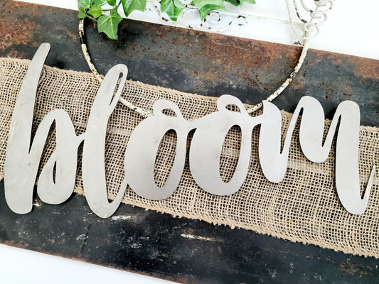 bloom metal script word sign in raw steel
