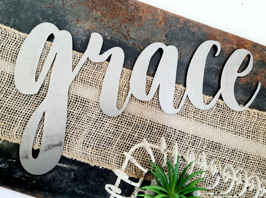 grace metal script word sign in raw steel