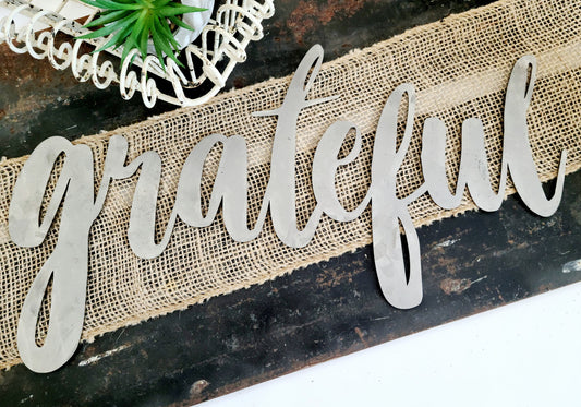 grateful metal script word sign in raw steel