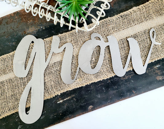 grow metal script word sign in raw steel