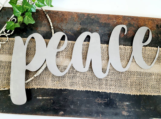peace metal script word sign in raw steel