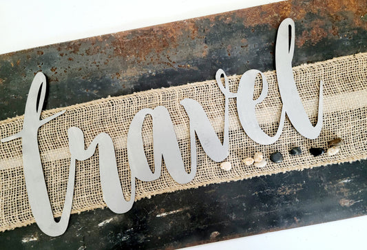 travel metal script word sign in raw steel