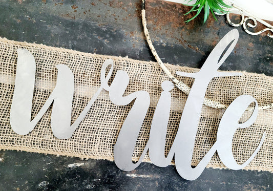 write metal script word sign in raw steel