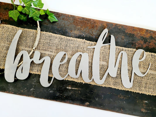 breathe metal script word sign in raw steel