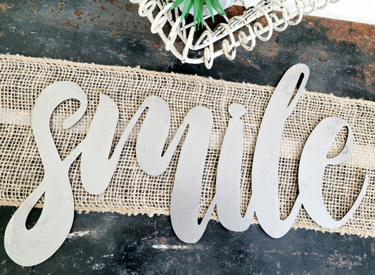 smile metal script word sign in raw steel