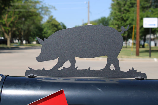Black pig mailbox topper installed on a mailbox