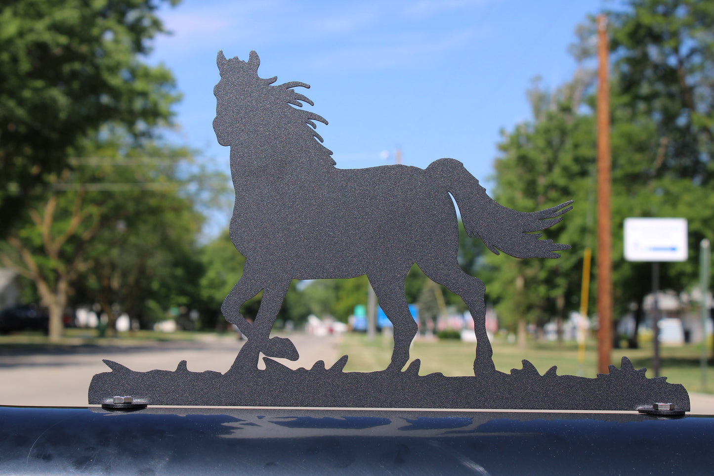 Black running horse mailbox topper installed on a mailbox