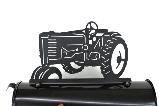Black vintage tractor mailbox topper installed on a mailbox