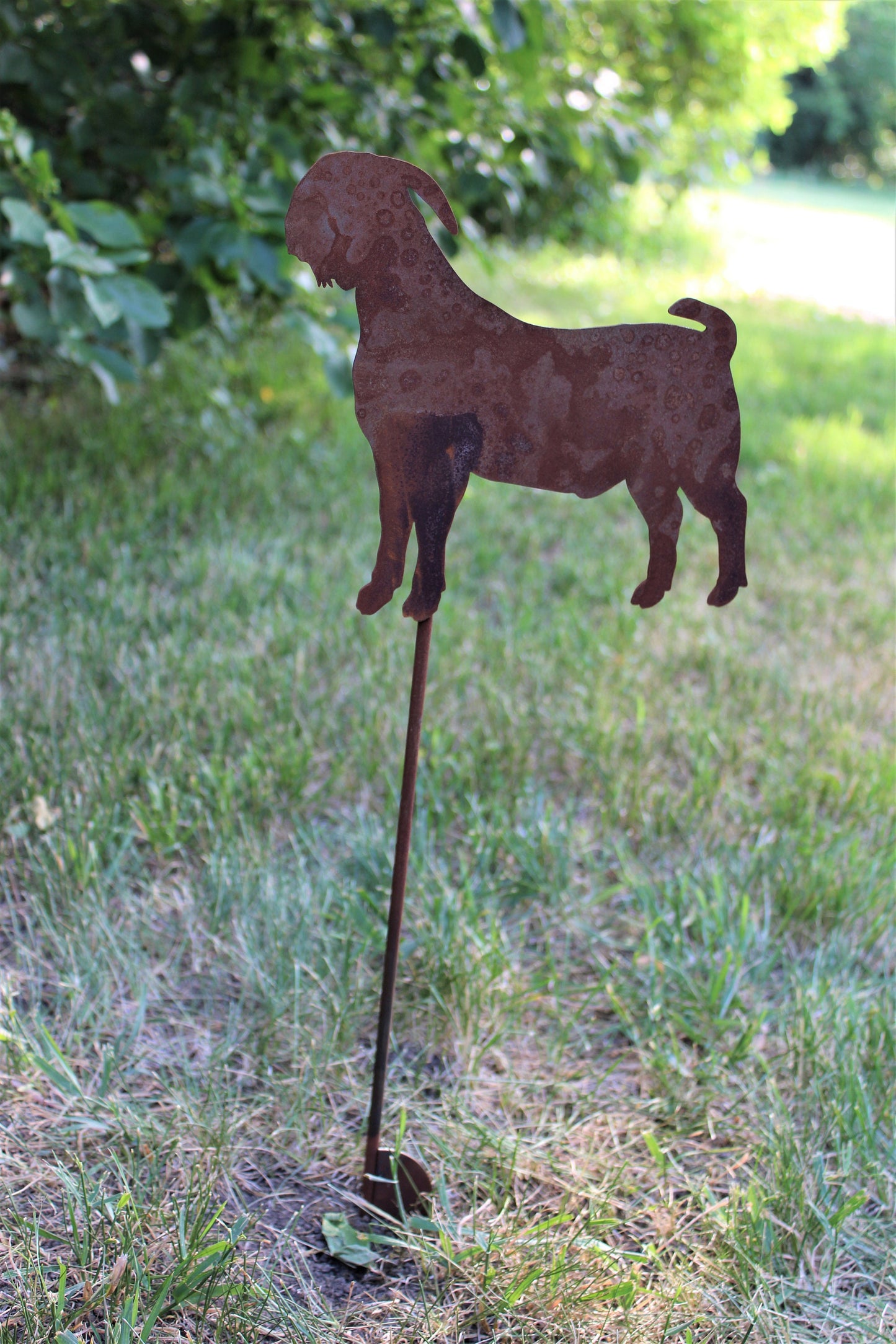 Rusty metal goat garden stake