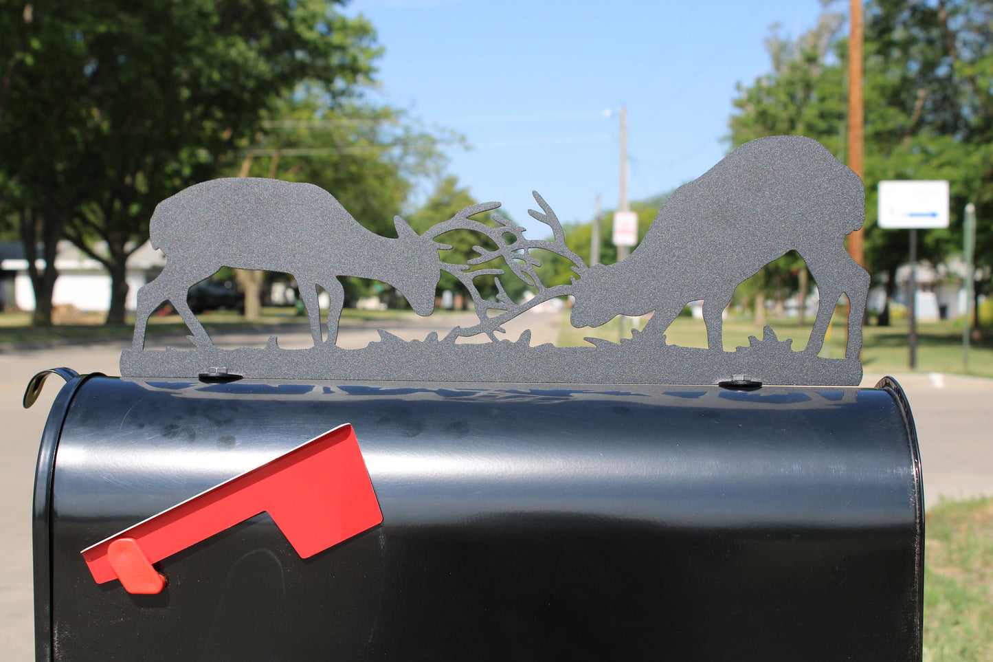 Black fighting deer mailbox topper with address installed on a mailbox.