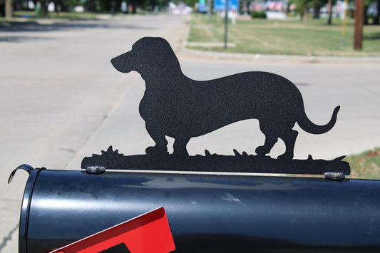 Black dachshund mailbox topper installed on a mailbox
