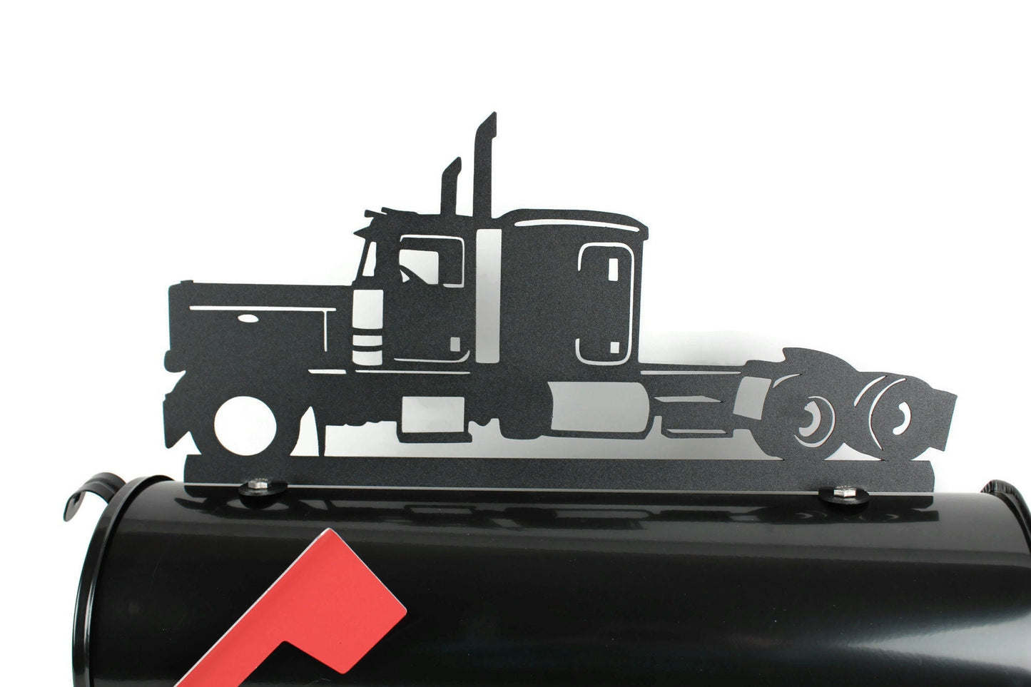 Black semi truck mailbox topper installed on a mailbox