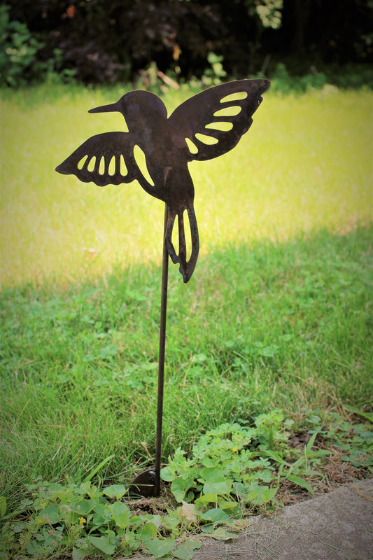 Metal hummingbird garden stake in rust