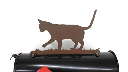 Dark brown cat mailbox topper installed on a mailbox.