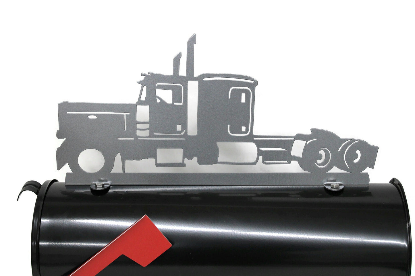 Metallic dark gray semi truck mailbox topper installed on a mailbox