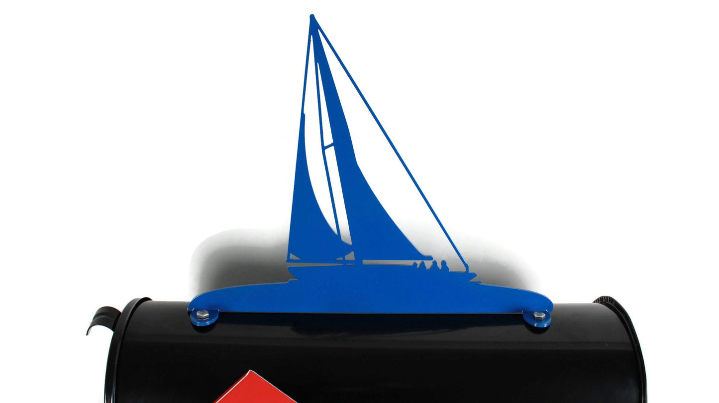 Blue sailboat mailbox topper installed on a mailbox