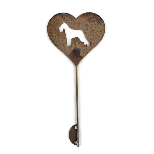 Heart-shaped rusty garden stake sign in rust with a schnauzer dog silhouette