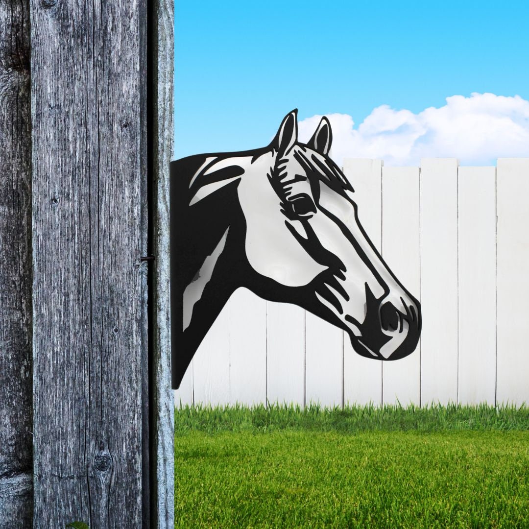 Black powder coat metal horse head peeking around a tree