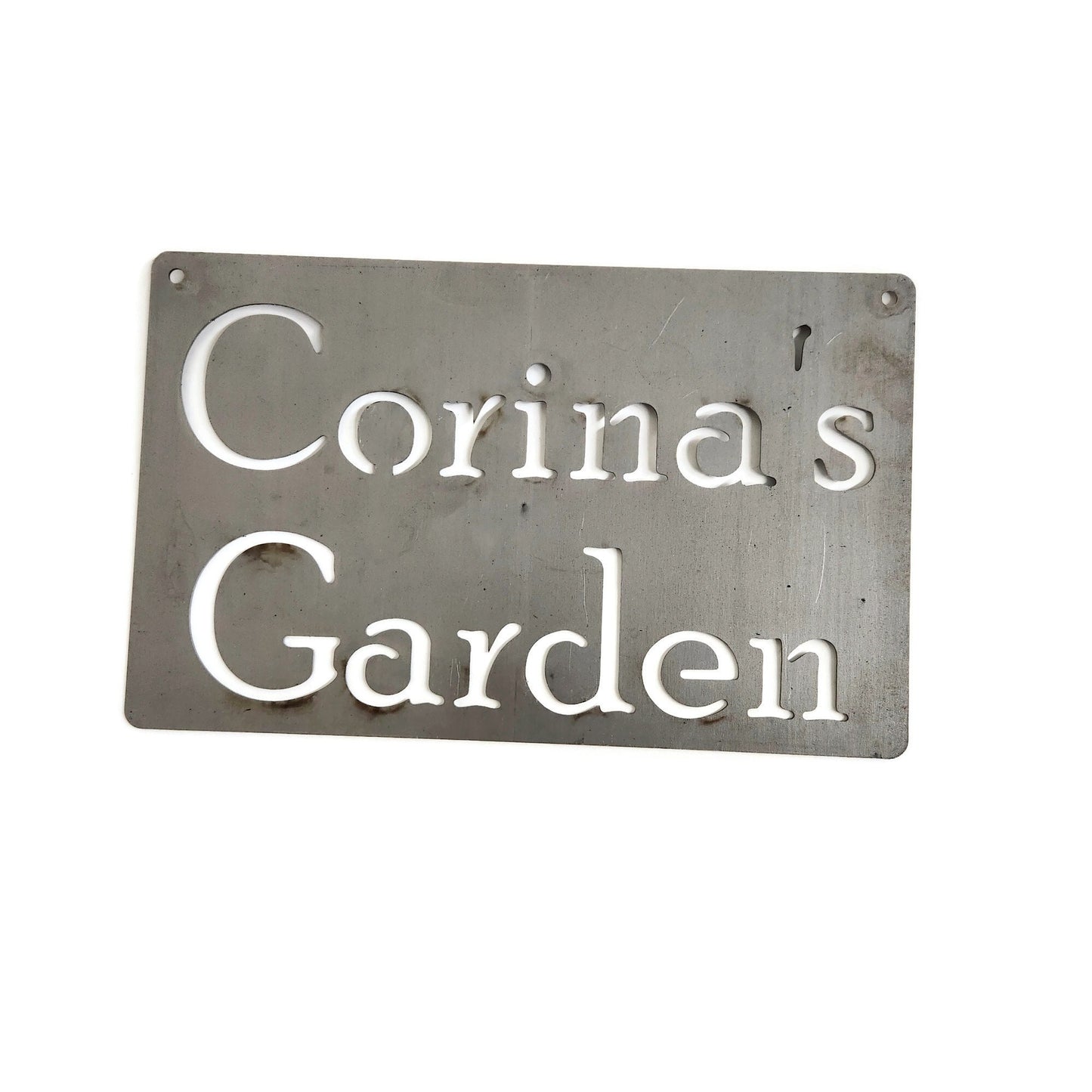 Custom hanging garden sign in raw steel with a wire hanger and Corina's Garden for text