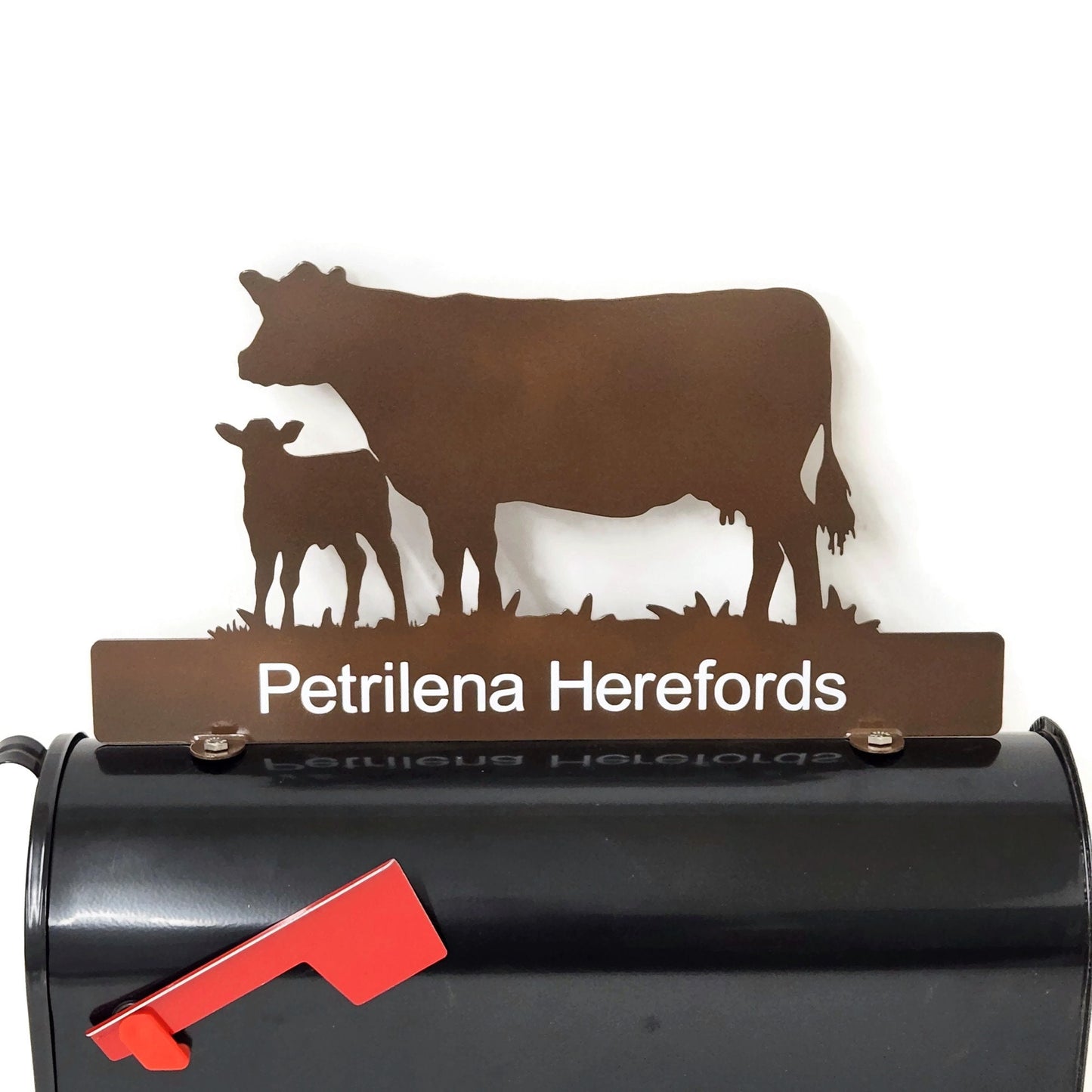 Gloss brown cow and calf standing mailbox topper with custom name installed on a mailbox.
