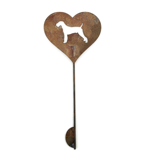 Heart-shaped rusty garden stake sign in rust with an airedale dog silhouette