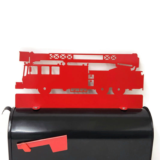 Red fire truck custom mailbox topper installed on a mailbox.