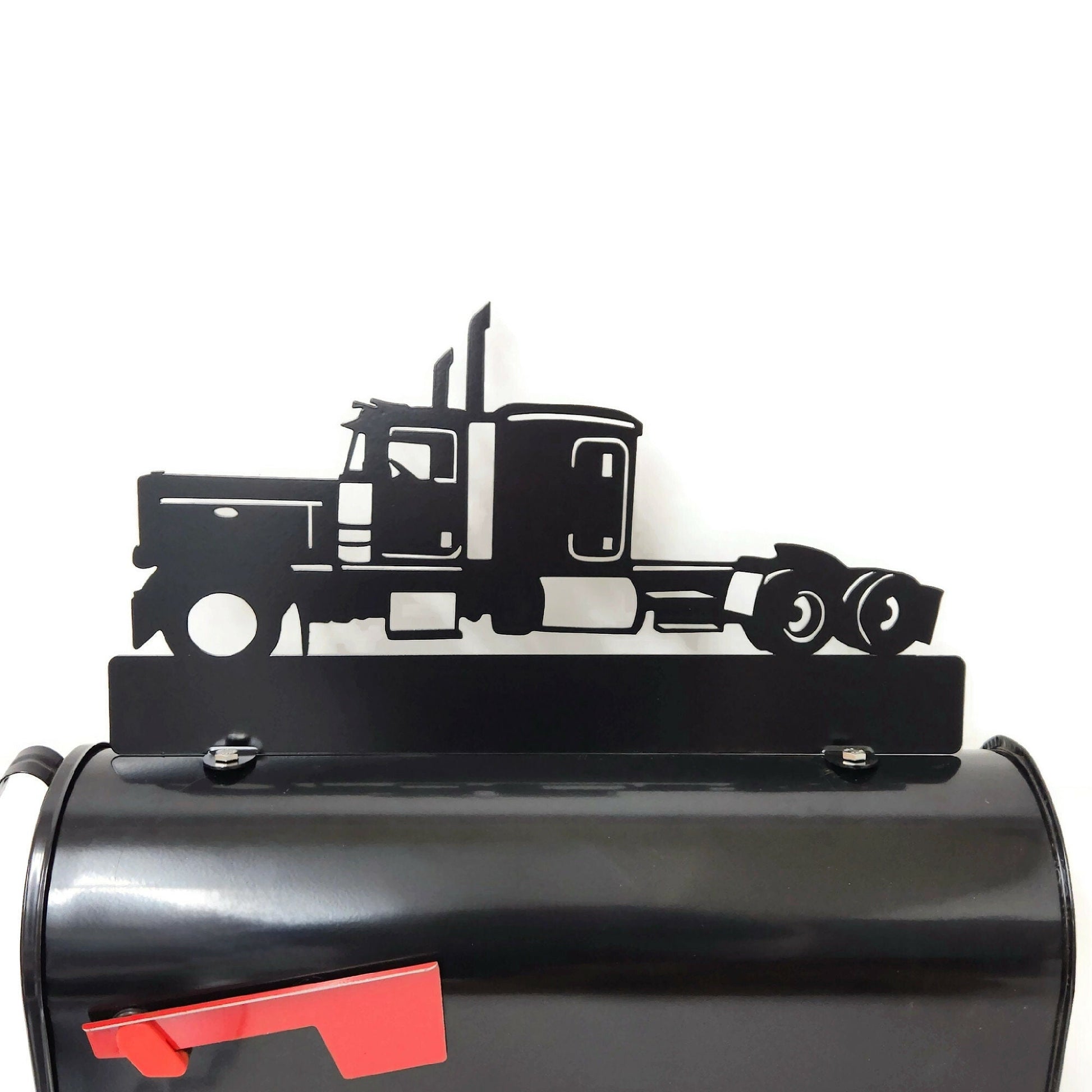 Black semi truck custom mailbox topper installed on a mailbox