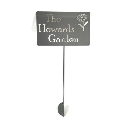Custom metal garden stake in raw steel with a flower and The Howards' Garden for text