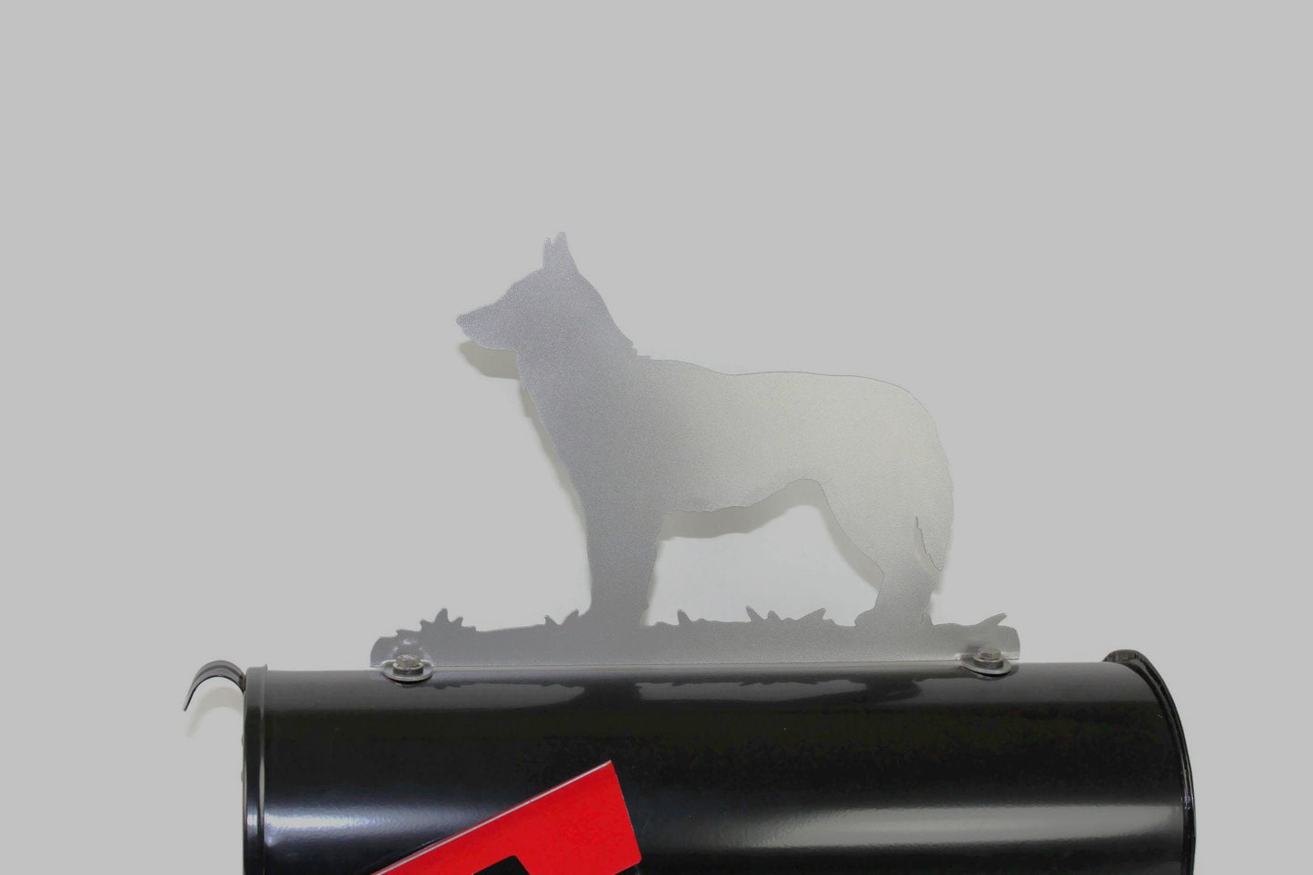 Silver Siberian Husky mailbox topper installed on a mailbox