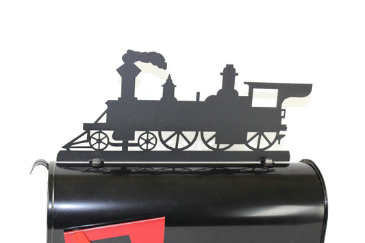 Black train engine mailbox topper installed on a mailbox