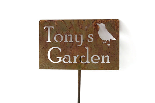 Custom metal garden stake in rust with a bird and Tony's Garden for text