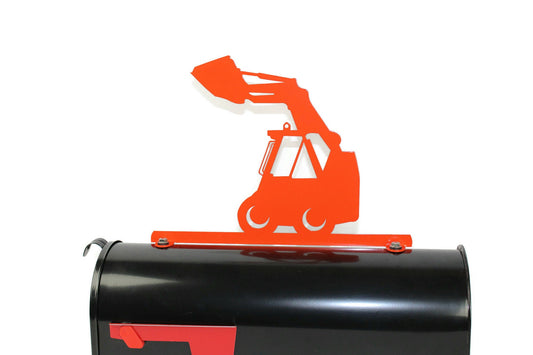 Orange skid loader mailbox topper installed on a mailbox