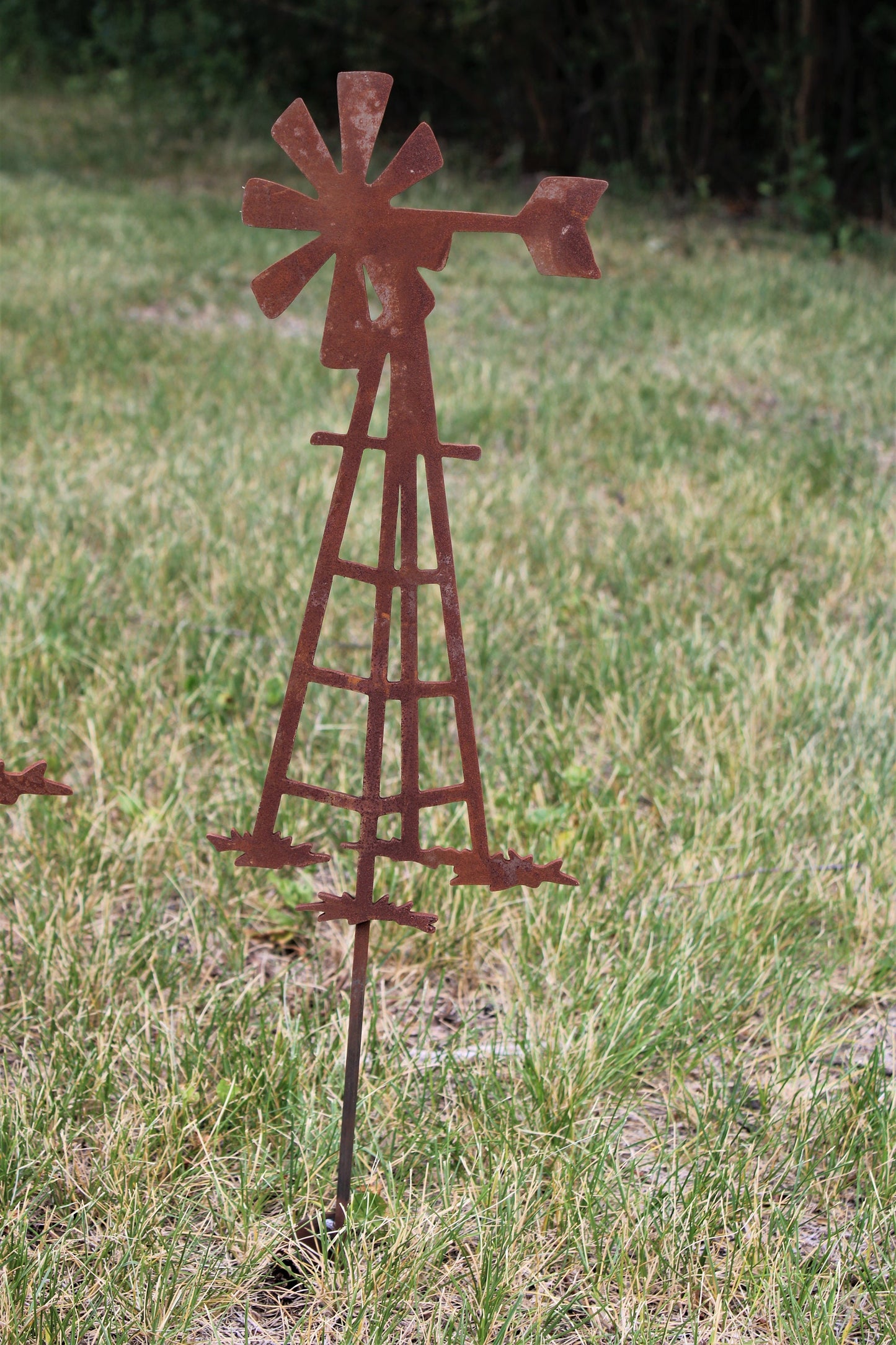 Rusty metal windmill garden stake
