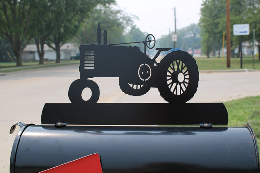 Black vintage tractor custom mailbox topper installed on a mailbox