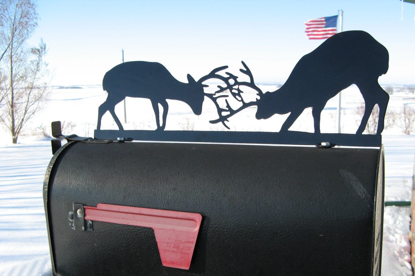 Black fighting deer mailbox topper with address installed on a mailbox.