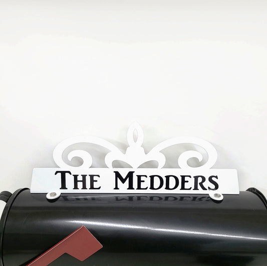 White swirl custom mailbox topper with custom address installed on a mailbox.