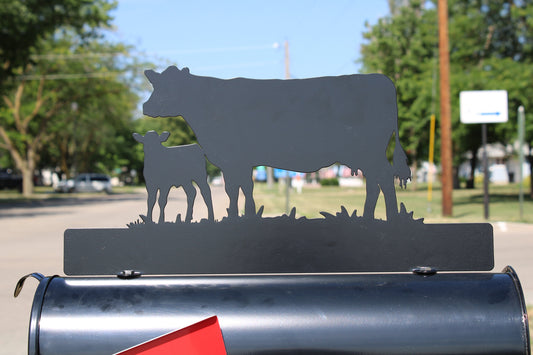 Black cow and calf standing mailbox topper with installed on a mailbox.